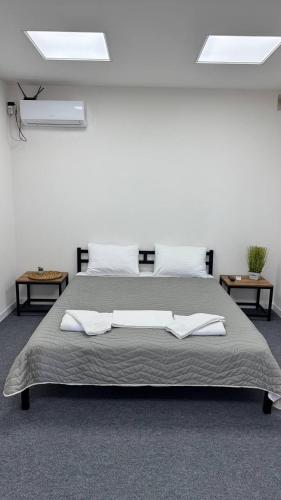 a bedroom with a large bed with two tables at Era Maris in Odesa