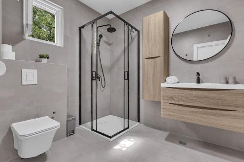 a bathroom with a shower and a toilet and a sink at Villa Magdalena in Zavojane