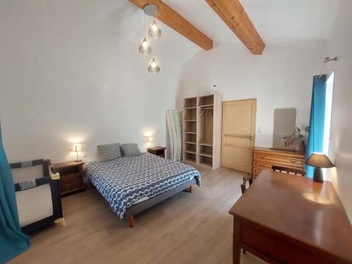 a bedroom with a bed and a wooden floor at La Fontchaude, gîte de charme au cœur de la nature à Cabrespine in Cabrespine