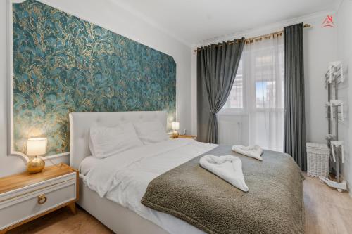 a bedroom with a bed with two towels on it at Nest45 in Roşu