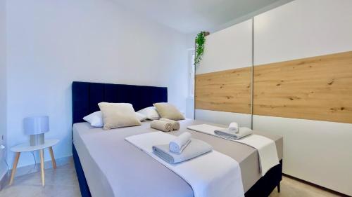 a bedroom with two beds with hats and towels on them at Apartment Bellaria in Jadranovo