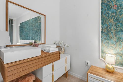 a bathroom with a sink and a mirror at Nest45 in Roşu