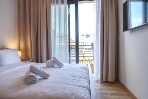 a bedroom with a bed with two pillows on it at Urban Liv Athens in Athens