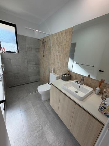 a bathroom with a sink and a toilet at Carnarvon Castle Eagle Bay in Dunsborough