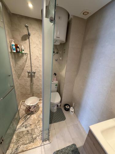 a bathroom with a shower and a toilet and a sink at Odyssée Atlantique Blue beach - Sidi Rahal - famille seulement in Sidi Rahal