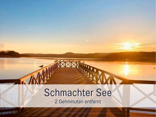 a dock on a lake with the sunset in the background at Appartementhaus Gutenberg - Ruhig & zentral in Binz - Parkplatz kostenlos - 6 Min zum Ostseestrand in Binz
