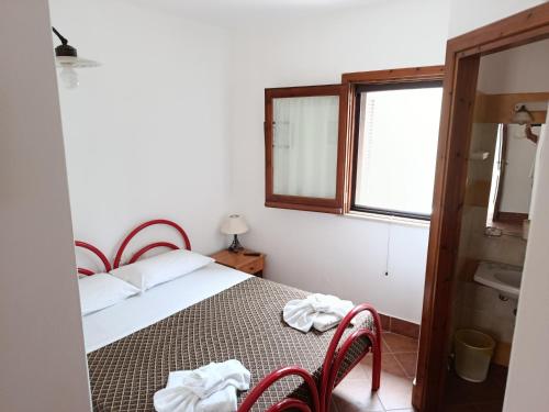 a bedroom with a bed and a window and a sink at Accomodation Villa Florio Parghelia in Fitili