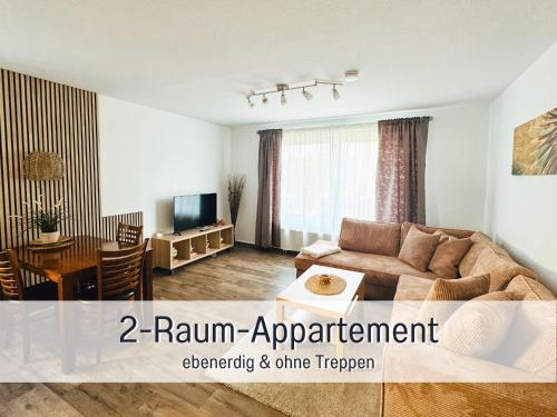 a living room with a couch and a table at Appartementhaus Gutenberg - Ruhig & zentral in Binz - Parkplatz kostenlos - 6 Min zum Ostseestrand in Binz