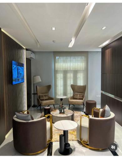 a lobby with couches and chairs and a table at Kim Royal Hotel and Suites in Festac Town