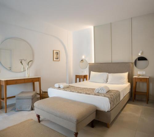 a bedroom with a bed and a table and a mirror at Nami Hotel & Suites in Stalís