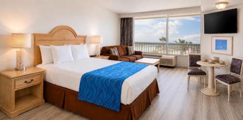 a hotel room with a bed and a balcony at Oceanfront Condo at Daytona Beach Resort in Daytona Beach