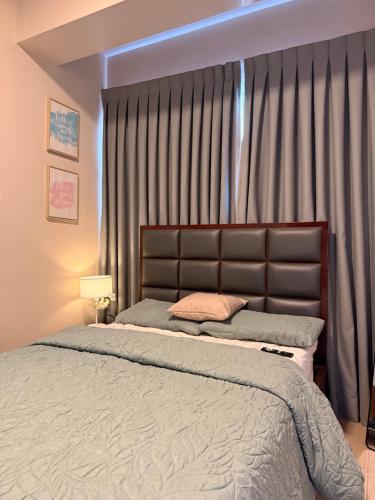 a bedroom with a bed and a large window at Ocean View Escape at The Mactan Newtown in Punta Engaño