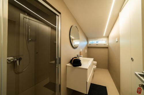 a bathroom with a shower and a sink and a mirror at Relais Lungolago Gavirate in Gavirate