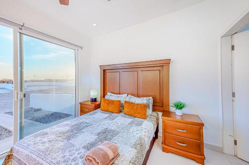 a bedroom with a bed and a large window at Dog-Friendly Villa with Heated Outdoor Pool, Hot Tub, Streaming, Balcony, Grill in Rosarito