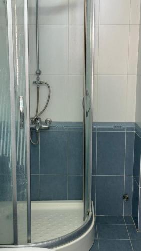 a shower with a glass door in a bathroom at Vy Home in Thanh Ðông (1)