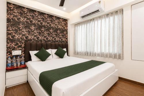 a bedroom with a white bed and a window at Hotel Platinum in Mumbai