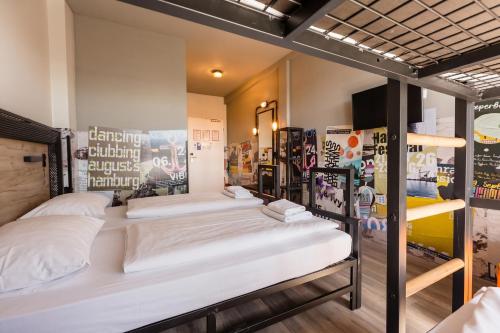 a room with three bunk beds in it at a&o Hamburg City in Hamburg