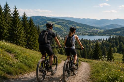 a man and woman riding bikes down a dirt road at Hotel Seidorf Luxury Wellness & Spa in Karpacz