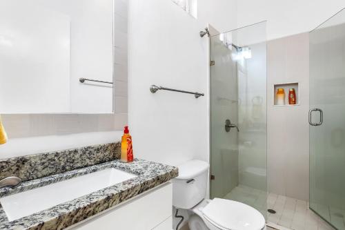 a bathroom with a sink and a toilet and a shower at Dog-Friendly Beach Haven with Heated Pool, Hot Tub, Kitchenette, Patio, AC in Rosarito