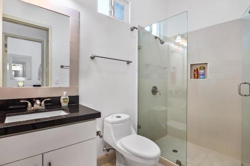 a bathroom with a toilet and a glass shower at Bright Dog-Friendly Villa with Beach Views, Private Patio, Outdoor Pool, Kitchen in Rosarito