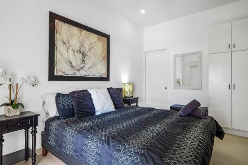 a bedroom with a king sized bed and a table at Bright Dog-Friendly Villa with Beach Views, Private Patio, Outdoor Pool, Kitchen in Rosarito