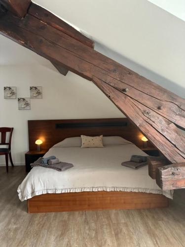 a bedroom with a large bed in a attic at Auberge de la Charrue in Romanel-sur-Lausanne