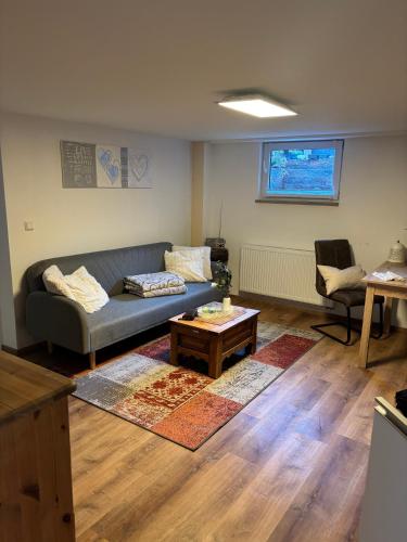 a living room with a couch and a table at Small 45 M² Apartment in Bad Kreuznach
