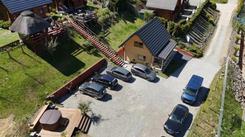 a group of cars parked in a parking lot at Domek u Pusi z jacuzzi in Solina