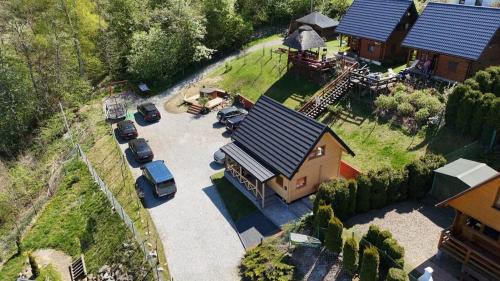 an aerial view of a house with cars parked outside at Domek u Pusi z jacuzzi in Solina