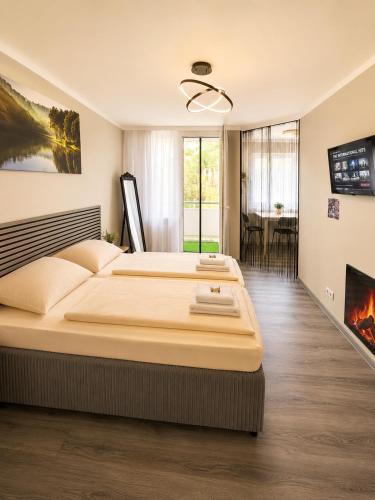 a bedroom with a large bed and a fireplace at Apartment Hotel in Nuremberg