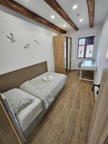 a bedroom with a bed and a desk at Fisherman's Lounge in Izola