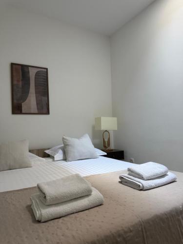 a bedroom with two towels on a bed at Laganini Apartments in Split
