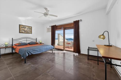 a bedroom with a bed and a view of the ocean at Villa Konstantina in Orasac