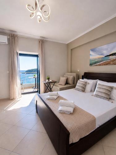 a bedroom with a bed with a view of the ocean at Dina's Apartment in Himare