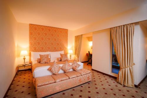 a hotel room with a bed and a couch at Avari Lahore Hotel in Lahore