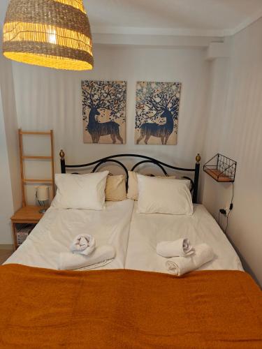 a bedroom with a bed with towels on it at Beach house IvMare in Ierissos