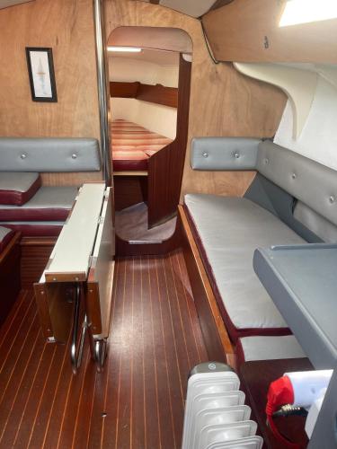 a small room with a bed and a desk in a boat at Voilier Miraflores in Cherbourg en Cotentin