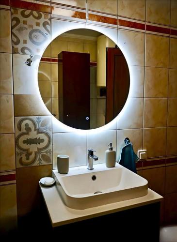 a bathroom with a sink and a mirror at Beach house IvMare in Ierissos