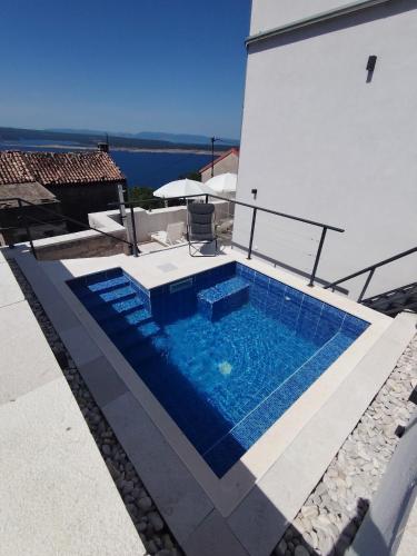 a swimming pool on the side of a house at Vila Ema Dramalj in Dramalj