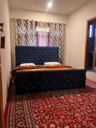 a blue bed in a room with a red carpet at Dal frozen in Srinagar