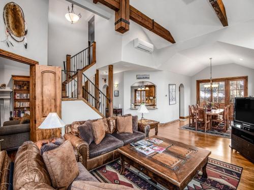 a living room with a couch and a table at Alpine Drive Chalet in Vail