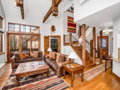 a living room with a couch and a table at Alpine Drive Chalet in Vail