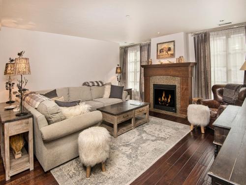 a living room with a couch and a fireplace at Ascent Condo 111 in Avon