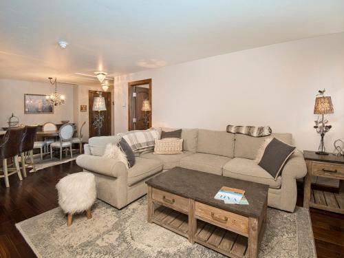 a living room with a couch and a table at Ascent Condo 111 in Avon