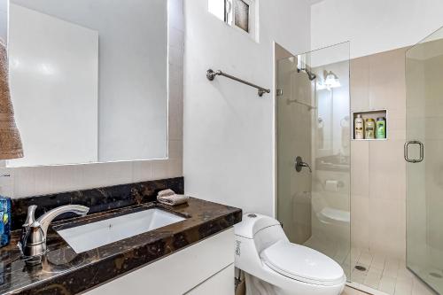 a bathroom with a toilet and a sink and a shower at Dog-Friendly Oceanfront Villa with Rooftop Patio, Pool Access, & Kitchen in Rosarito