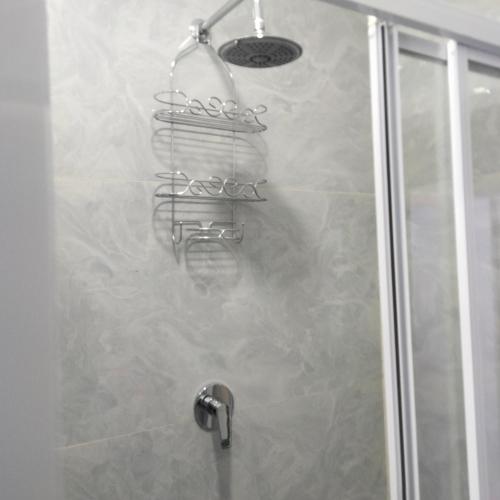 a shower stall with a shower head and a shower at Exclusive guest house in Modimolle