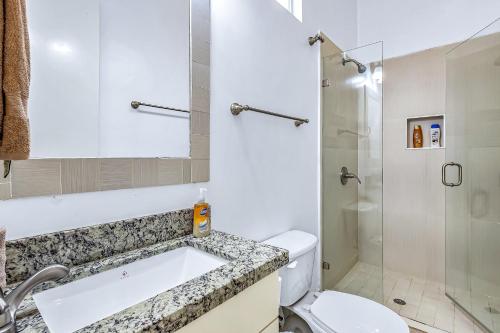 a bathroom with a toilet and a sink and a shower at Dog-Friendly Suite with Kitchenette, Heated Outdoor Pool, Hot Tub, Terrace, AC in Rosarito