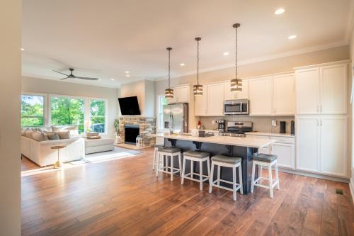 a kitchen with white cabinets and a kitchen island with bar stools at The Overlook at Lake James in Nebo