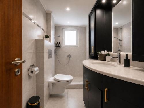 a bathroom with a toilet and a sink and a shower at Leas House in Preveza