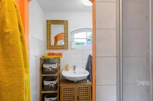 a bathroom with a sink and a mirror at Ferienhaus Reiseoase in Bützow